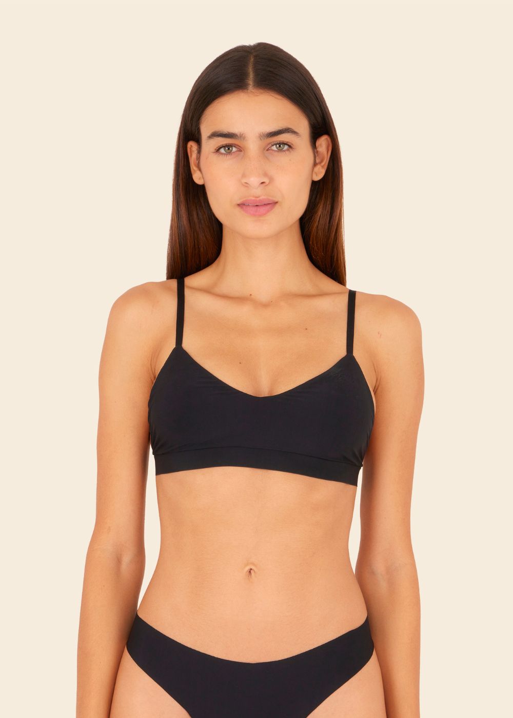 mujer en fondo blanco usando ropa interior de sosten y tanga en color negro